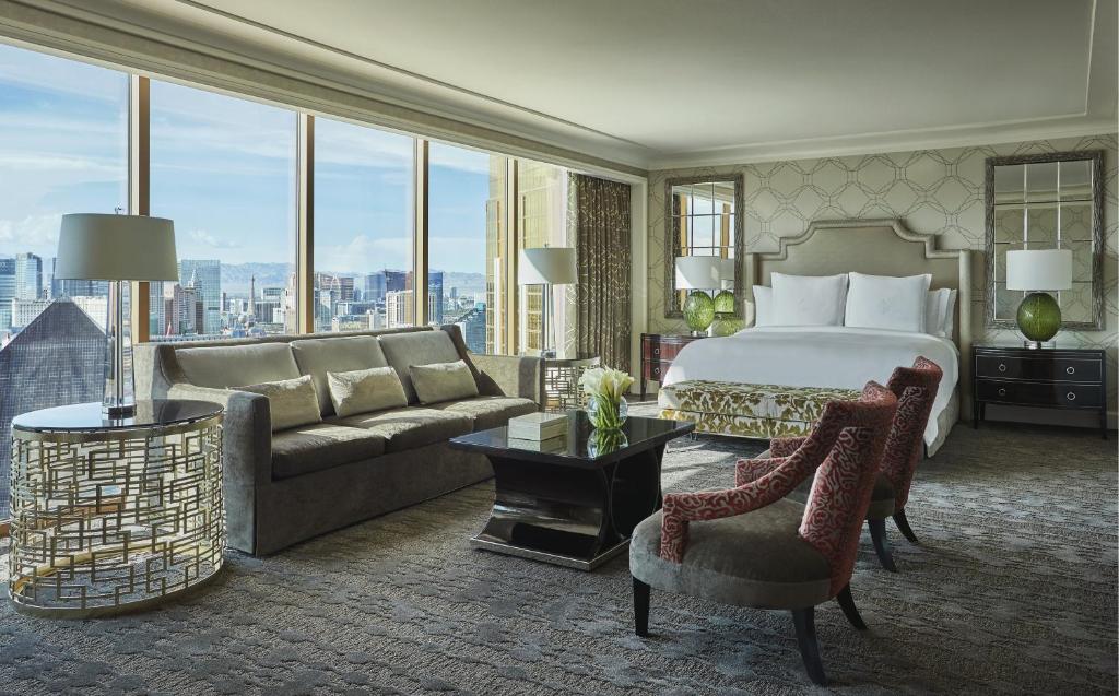 a hotel room with a bed and a large window at Four Seasons Hotel Las Vegas in Las Vegas