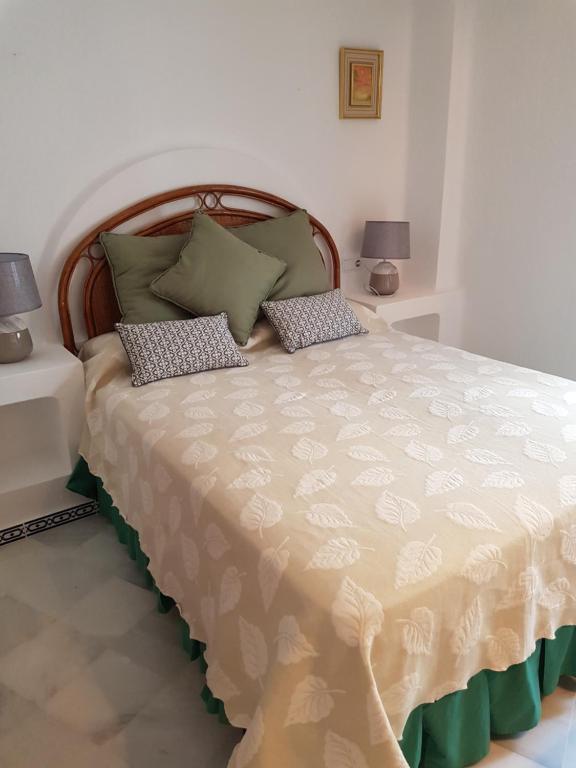 a bedroom with a large bed with two lamps at Martina in Torrevieja