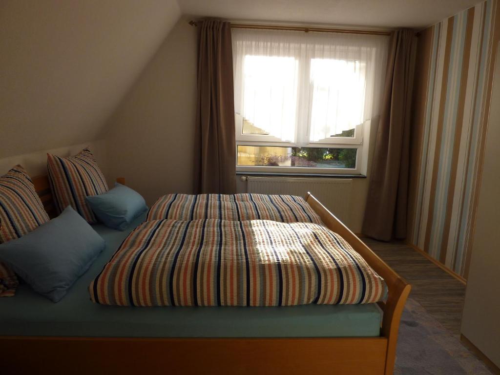 a bed sitting in a room with a window at Ferienwohnung Meer&mehr in Mulsum