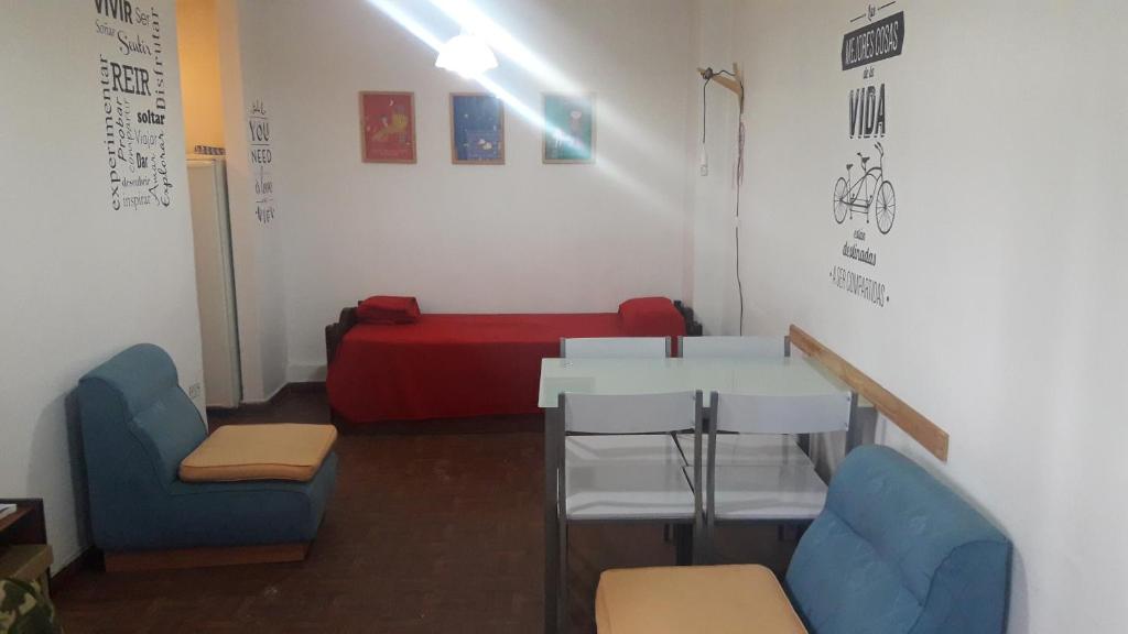 a room with a table and chairs and a couch at Departamento Córdoba in Cordoba