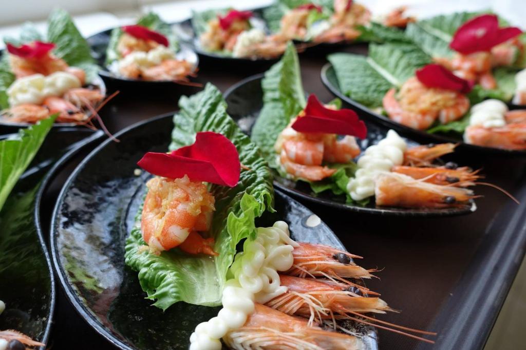 a group of plates of food with shrimp and lettuce at Tai-Yi Red Maple Resort in Puli