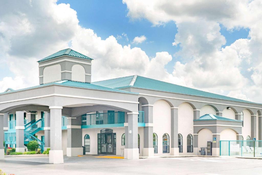 a large white building with a blue roof at Super 8 by Wyndham Murfreesboro in Murfreesboro