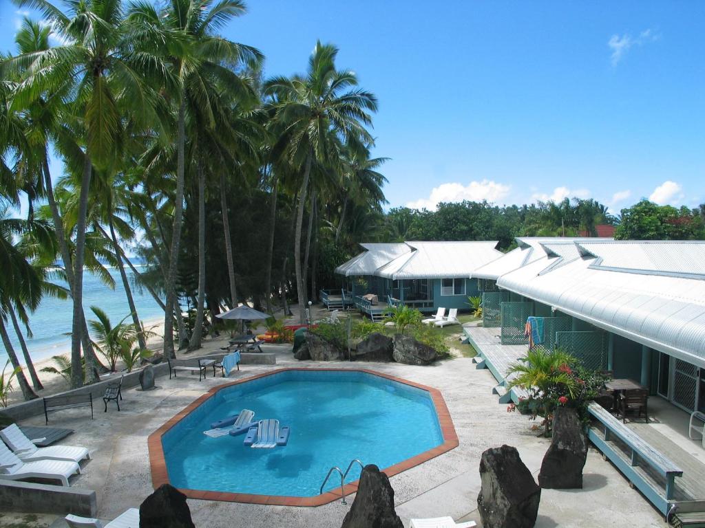 a resort with a swimming pool next to the beach at Sunhaven Beach Bungalows in Rarotonga