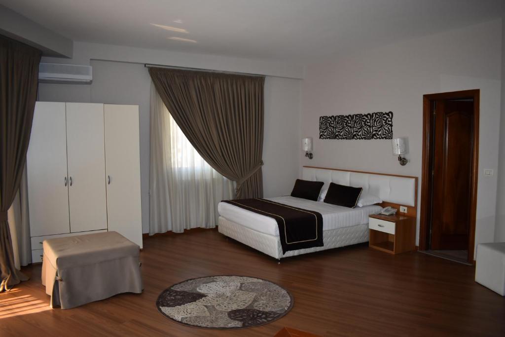 a hotel room with a bed and a table at Hotel Arvi in Durrës