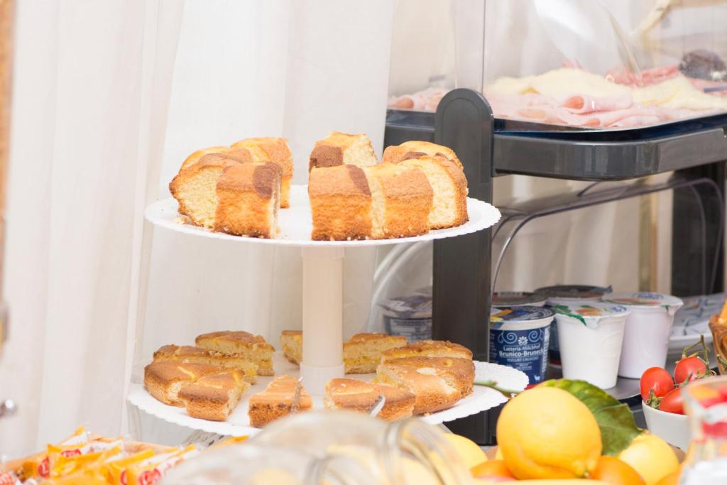 a three tiered plate of bread and pastries at Hotel Fontana in Amalfi