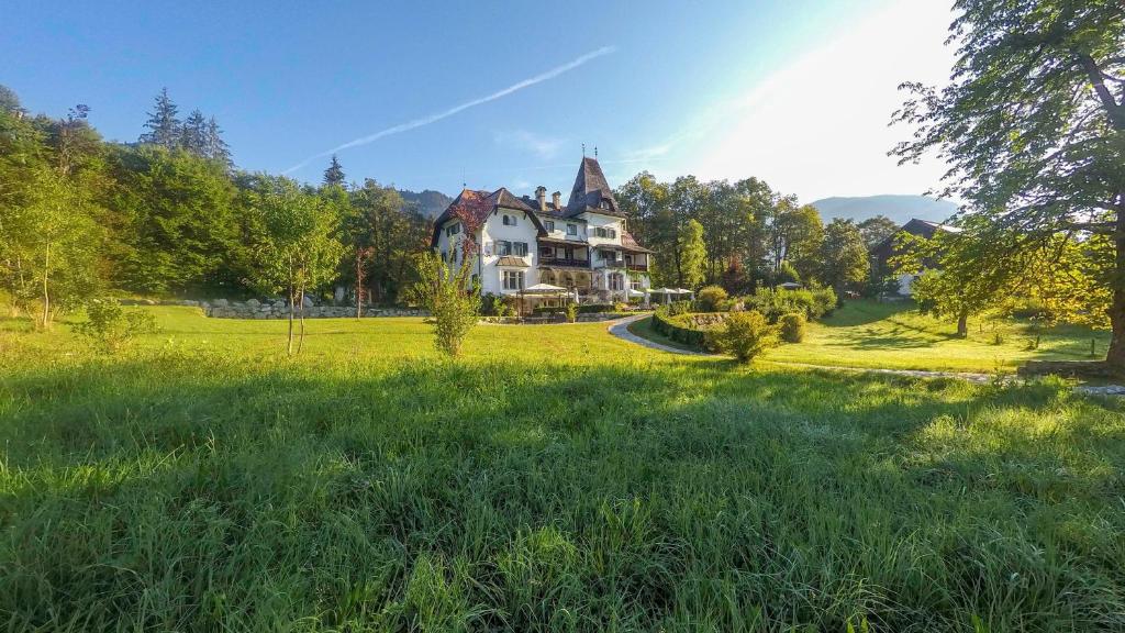 a large house in the middle of a field at Landhaus Koller in Gosau