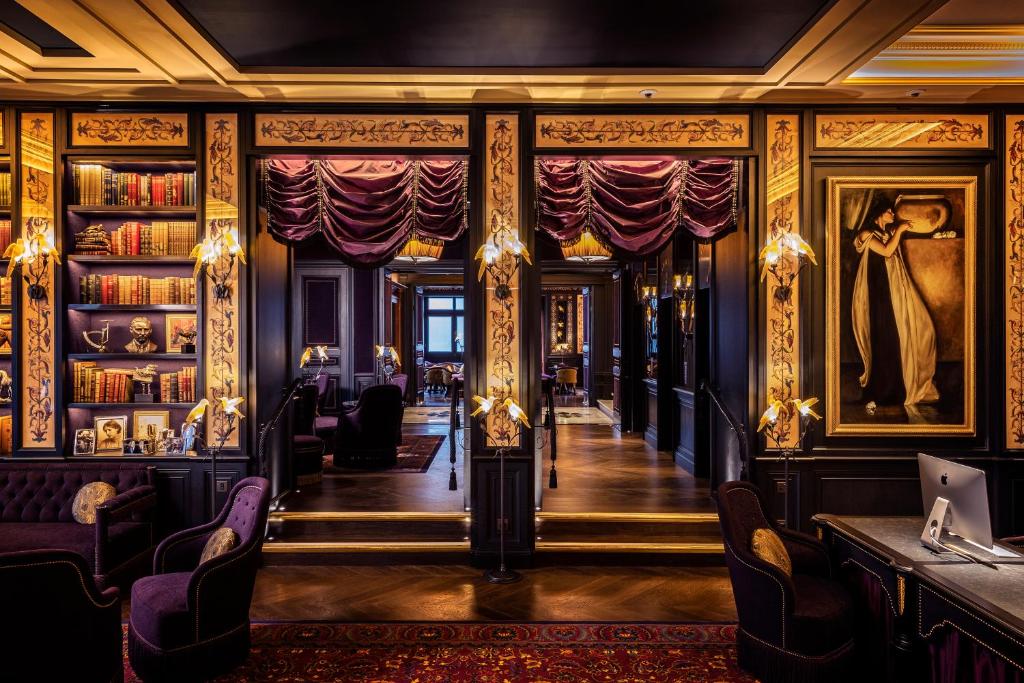 a room with a bar and a library of books at L'oscar London in London