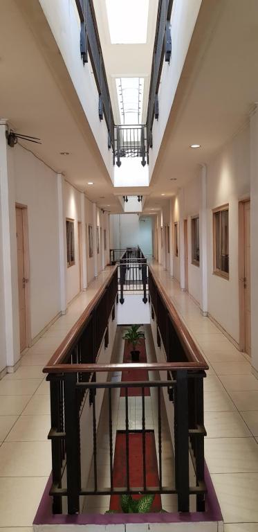 an empty hallway of a building with a long corridor at Hotel Dequr Jakarta Kota in Jakarta