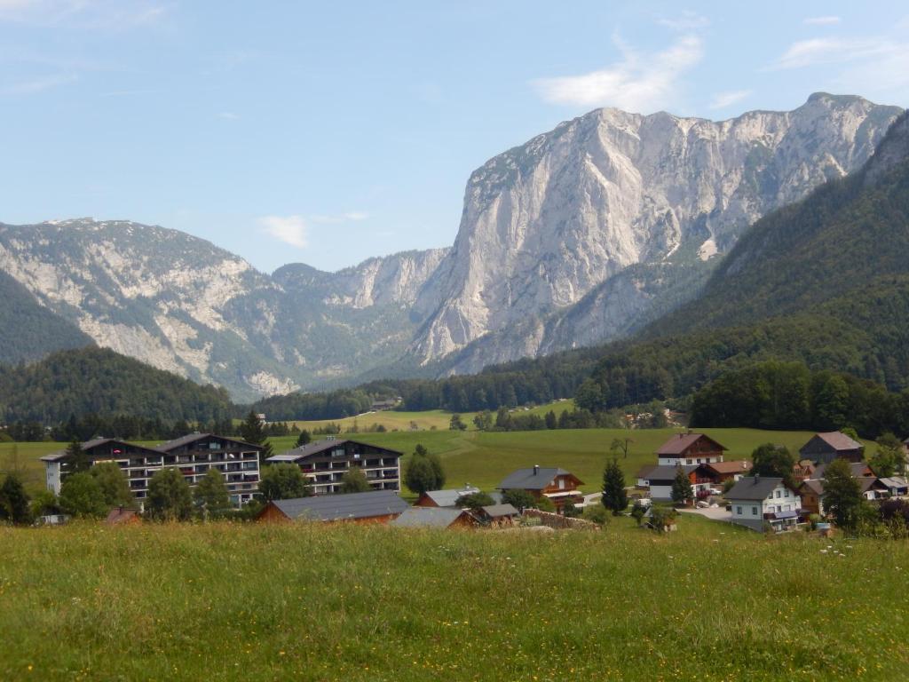 a village in a field with mountains in the background at "Gletscherblick" in Bad Aussee