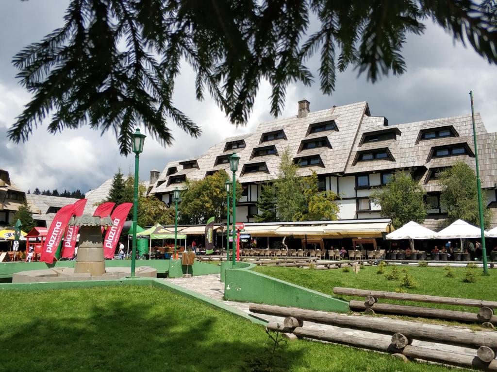 a large building with a park in front of it at Apartment Dunja Konaci in Kopaonik