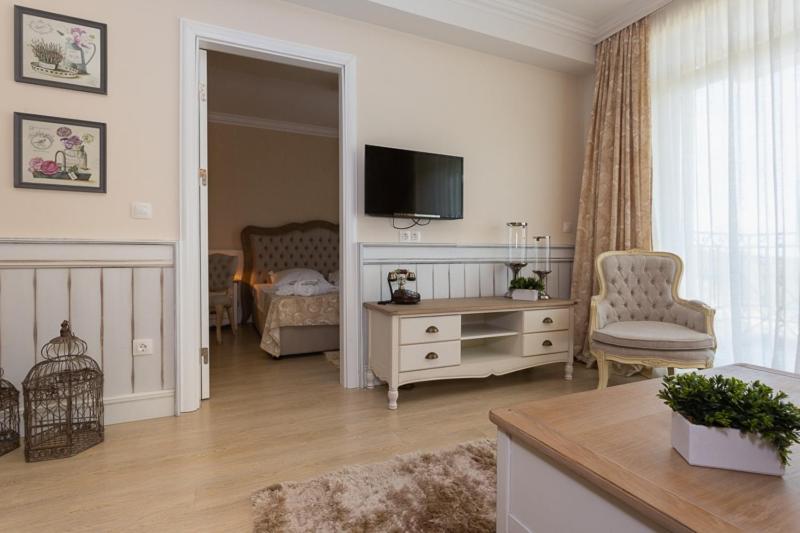 A television and/or entertainment centre at Therma Palace - All inclusive & Private Beach & Free Parking