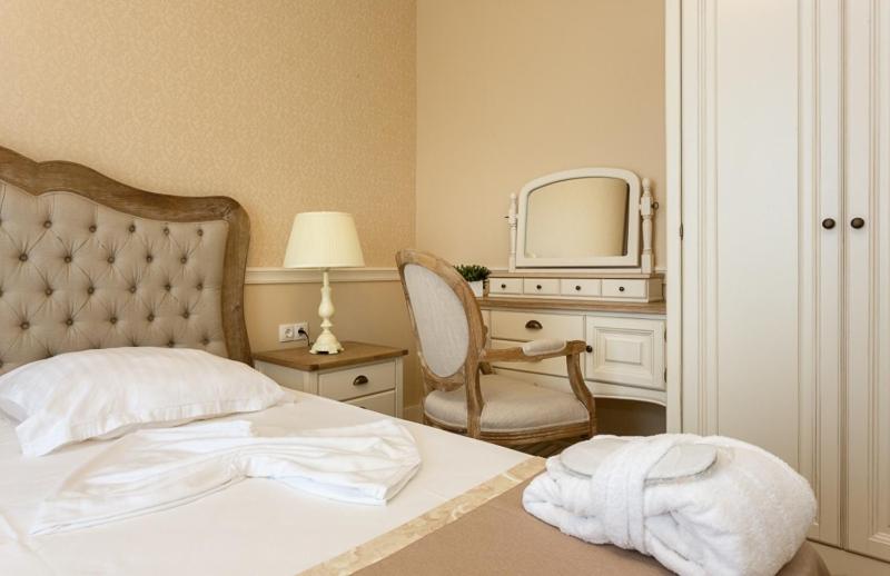 A bed or beds in a room at Therma Palace - All inclusive & Private Beach & Free Parking