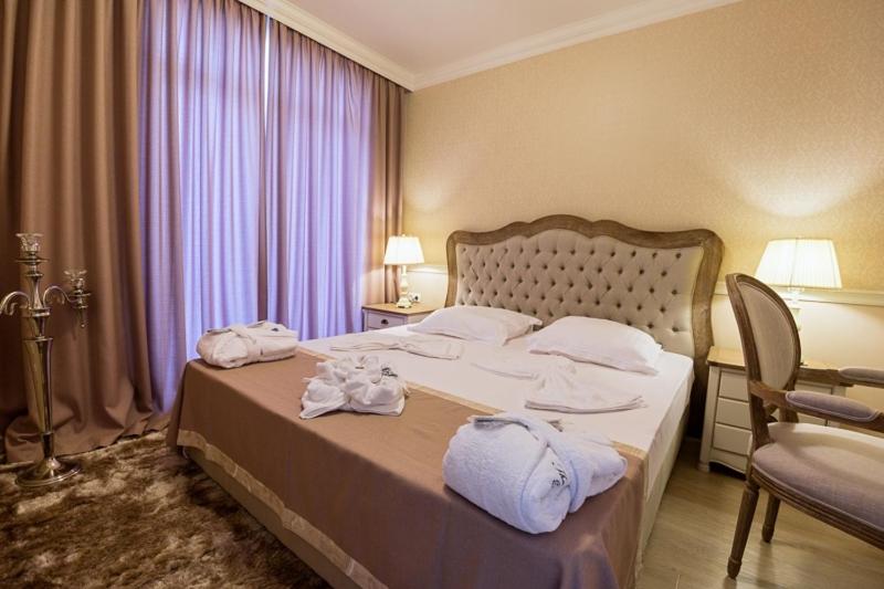 A bed or beds in a room at Therma Palace - All inclusive & Private Beach & Free Parking
