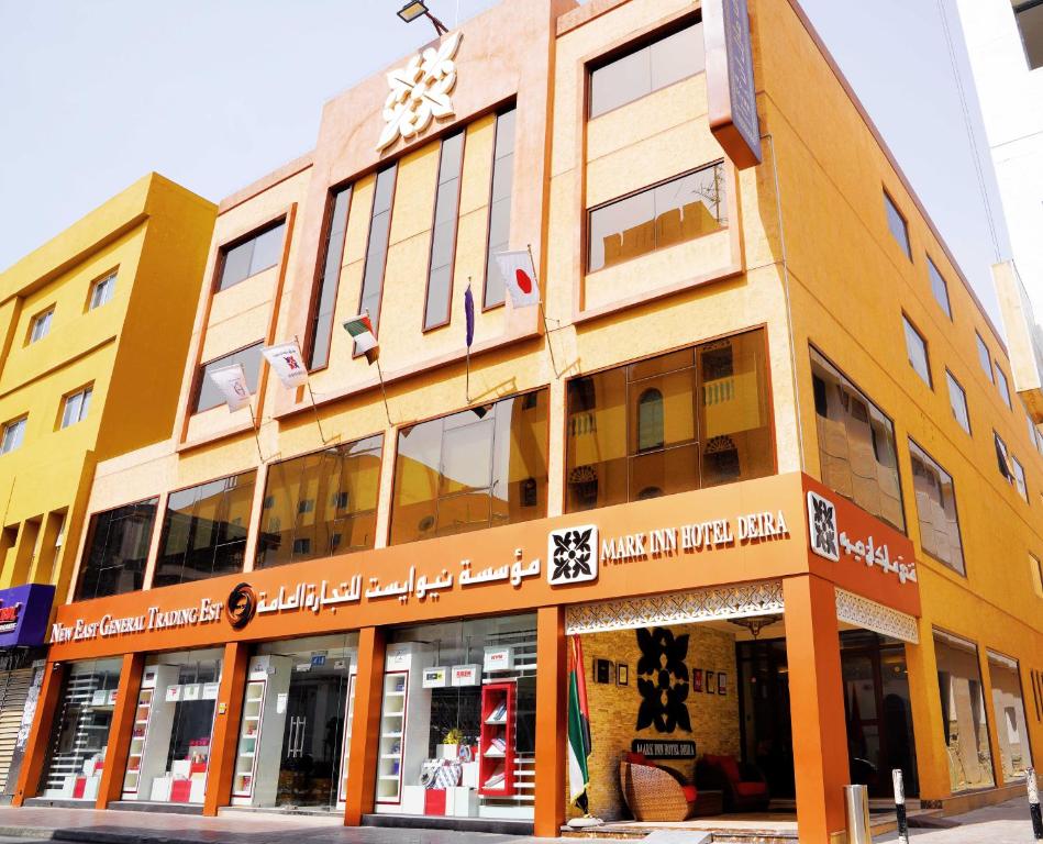 a building on a street with a store at Mark Inn Hotel Deira in Dubai