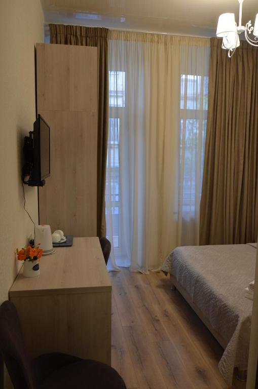 Postel nebo postele na pokoji v ubytování Hotel Griboedov
