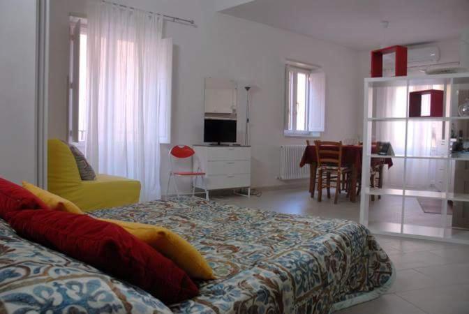 a bedroom with a bed and a living room and a kitchen at Casa Maddò in Castelbuono