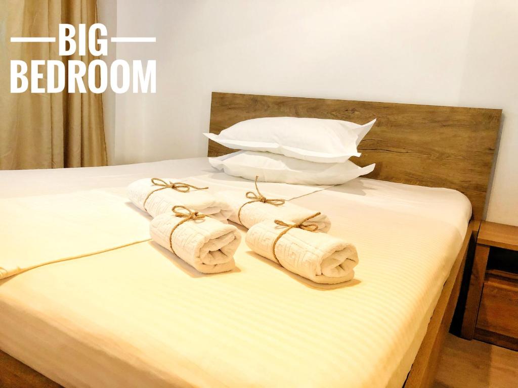 Una cama con tres toallas enrolladas. en ”Modern Apartment” Old City Constanta en Constanza
