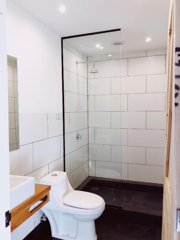 a bathroom with a toilet and a sink and a shower at El Establo in Puerto Natales