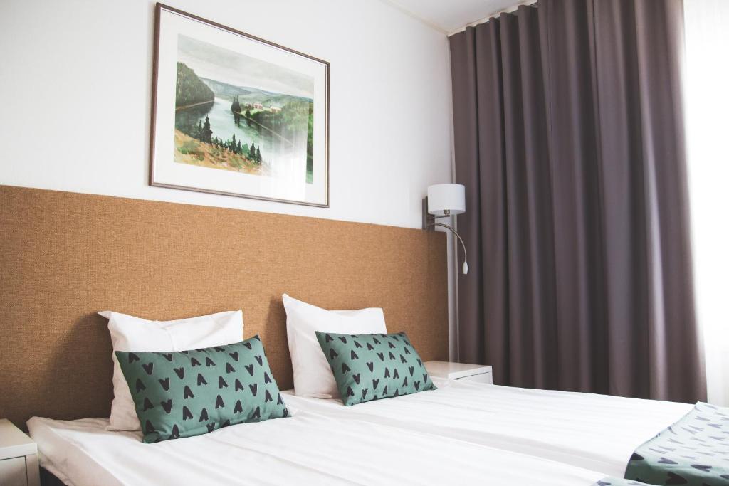 Postel nebo postele na pokoji v ubytování Hotel Aakenus