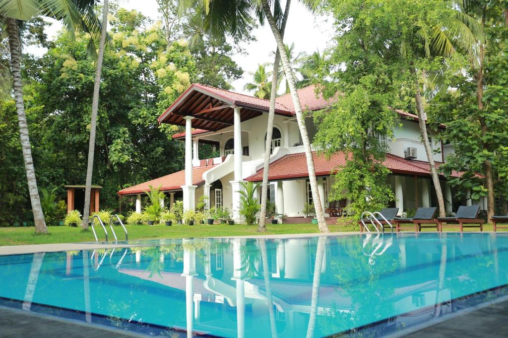 a resort with a swimming pool in front of it at The Villa Green Inn in Negombo