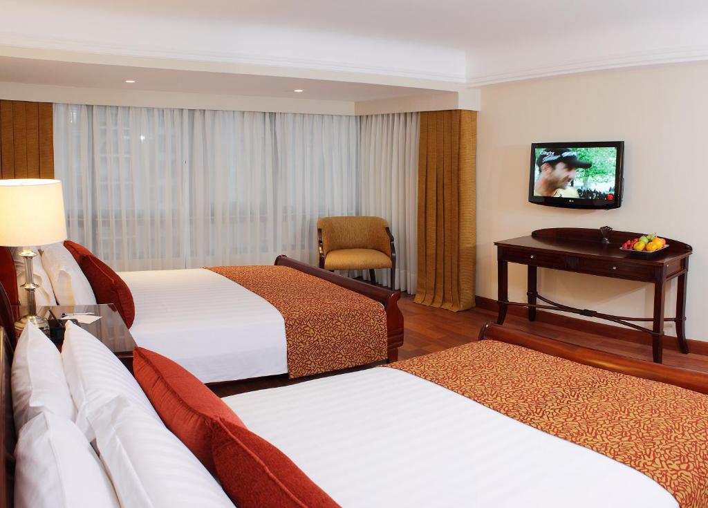 Postel nebo postele na pokoji v ubytování Hotel Estelar La Fontana