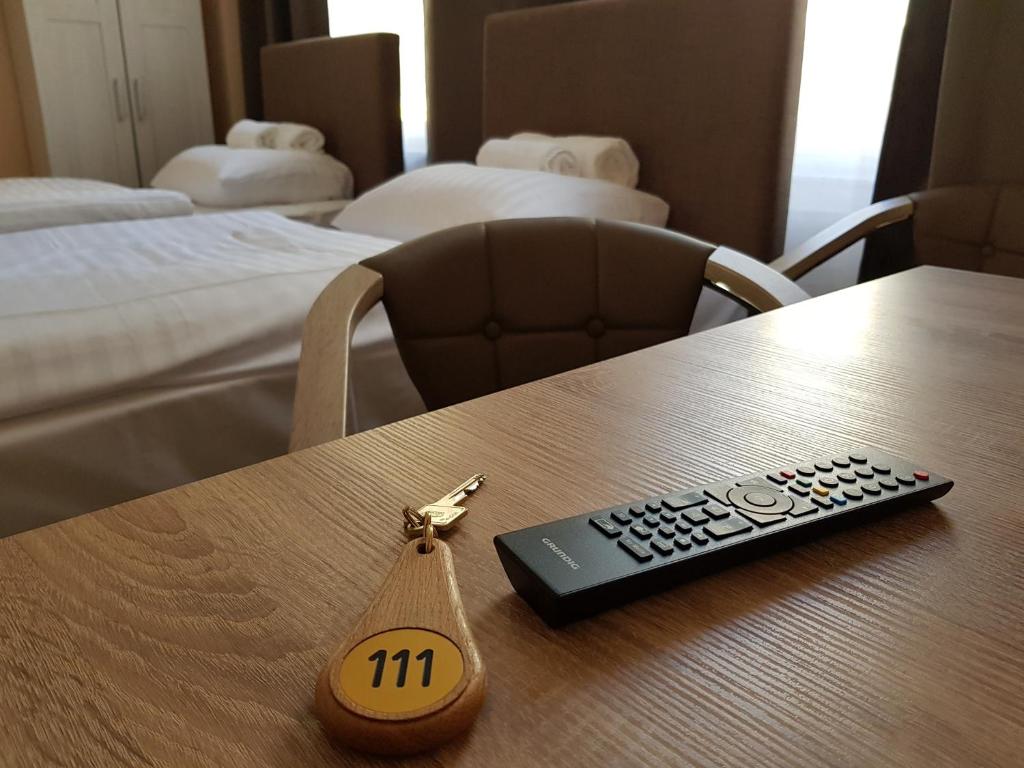 a remote control sitting on top of a table at Hotel-Residenz Oberurseler Hof in Oberursel
