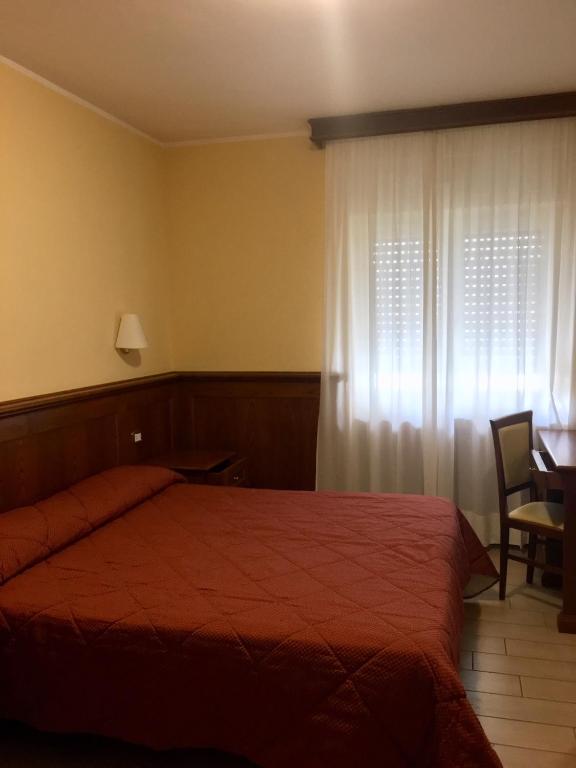 Postel nebo postele na pokoji v ubytování Hotel Sporting