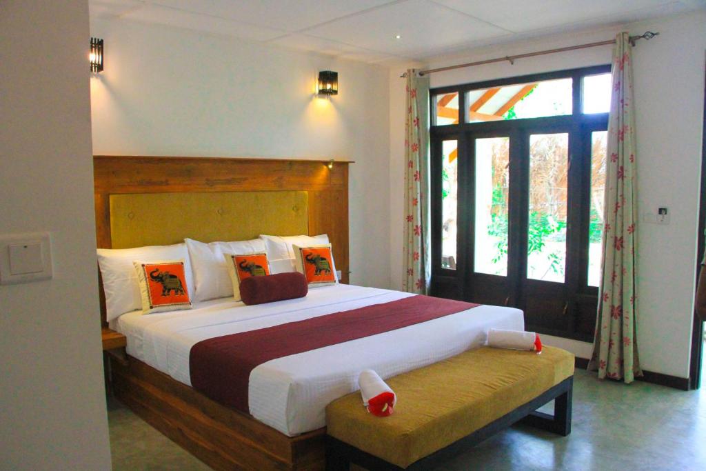 Postel nebo postele na pokoji v ubytování Palmyra Nature Resort Sigiriya