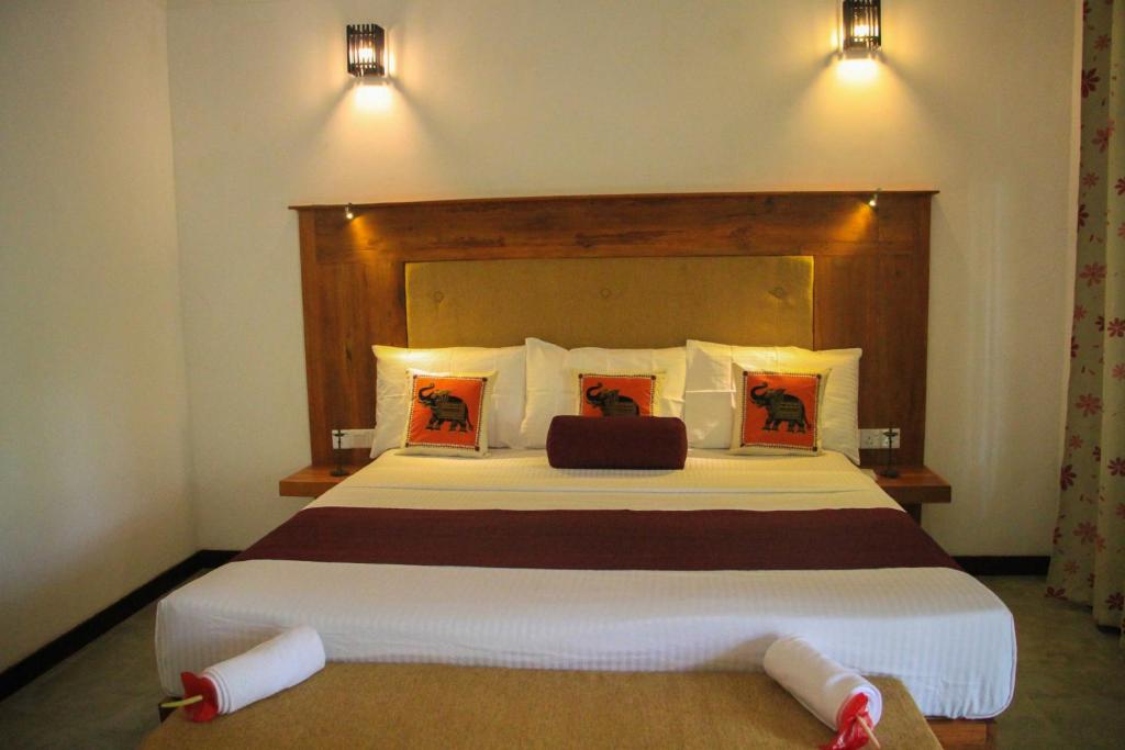 Postel nebo postele na pokoji v ubytování Palmyra Nature Resort Sigiriya