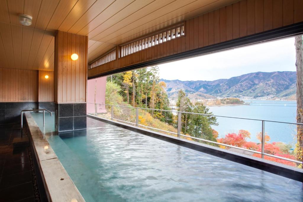 a swimming pool with a view of the water at Rakuyu in Fujikawaguchiko