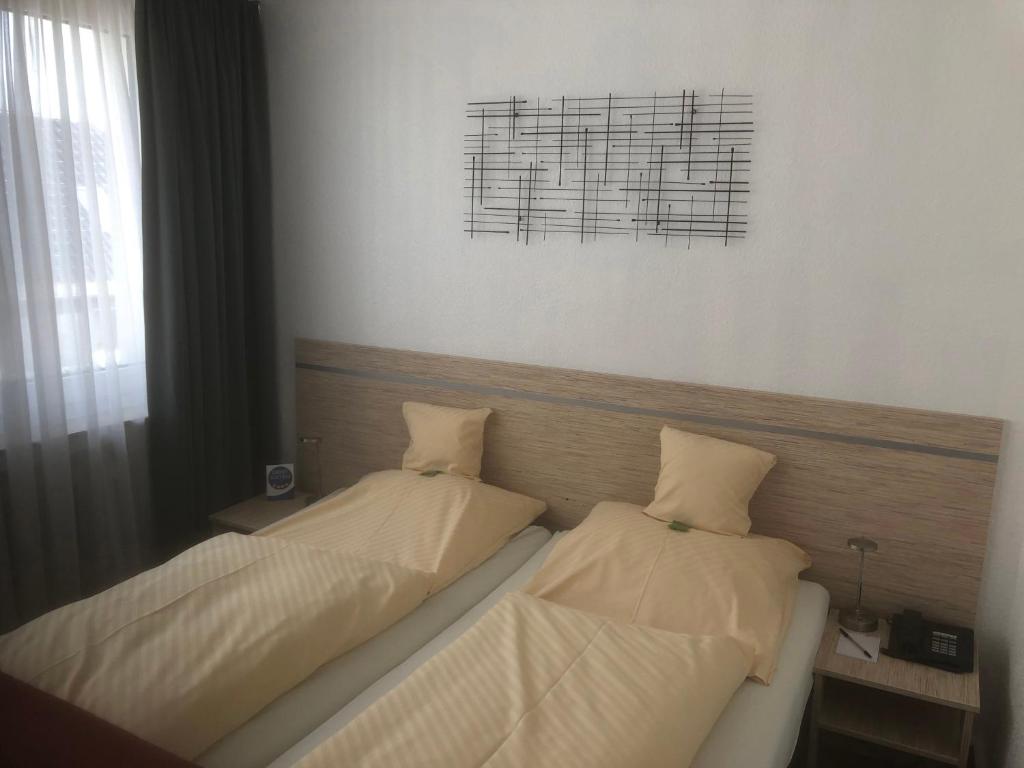 Postel nebo postele na pokoji v ubytování Hotel Sechzehn