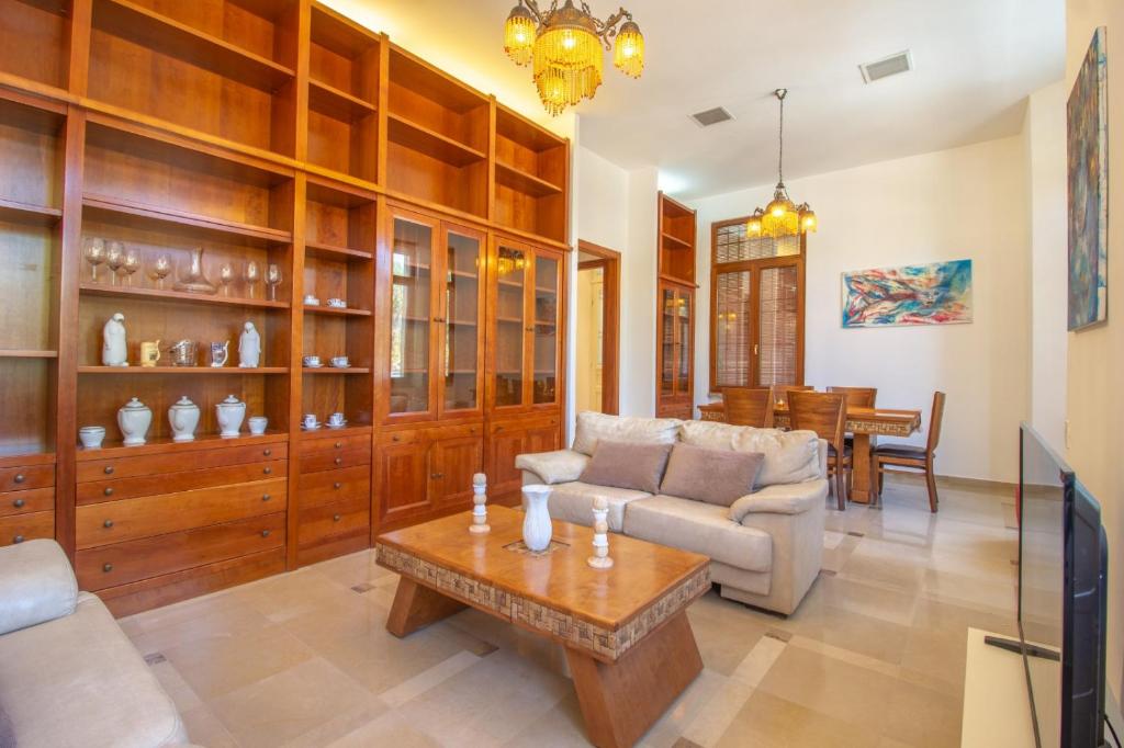 ein Wohnzimmer mit einem Sofa und einem Tisch in der Unterkunft Art Apartment In Mamila in Jerusalem