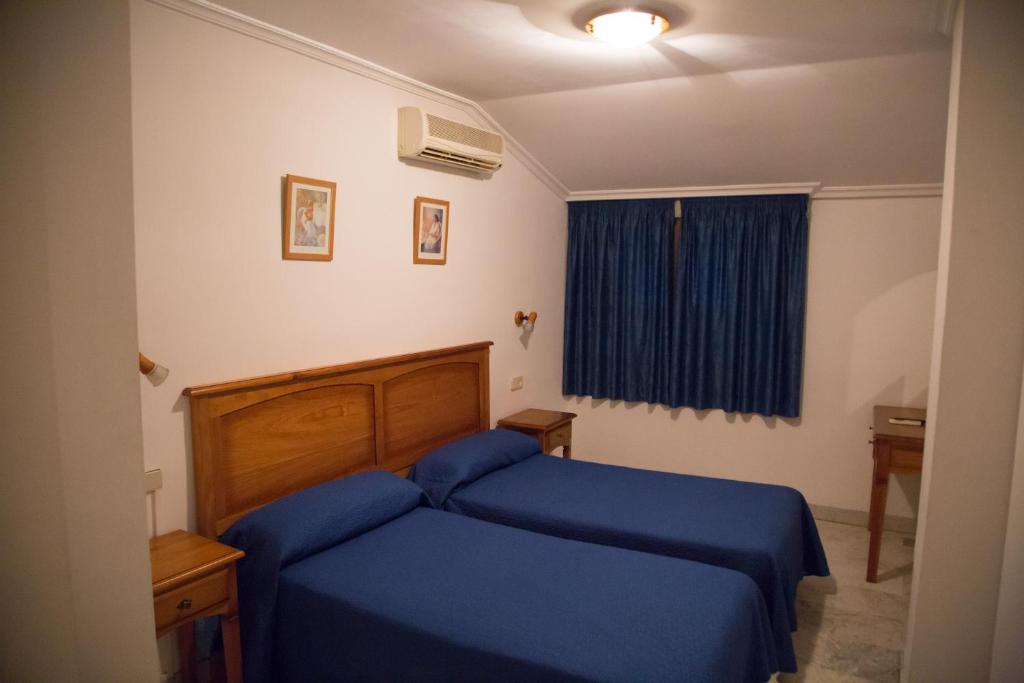 Postel nebo postele na pokoji v ubytování Hostal Acuario