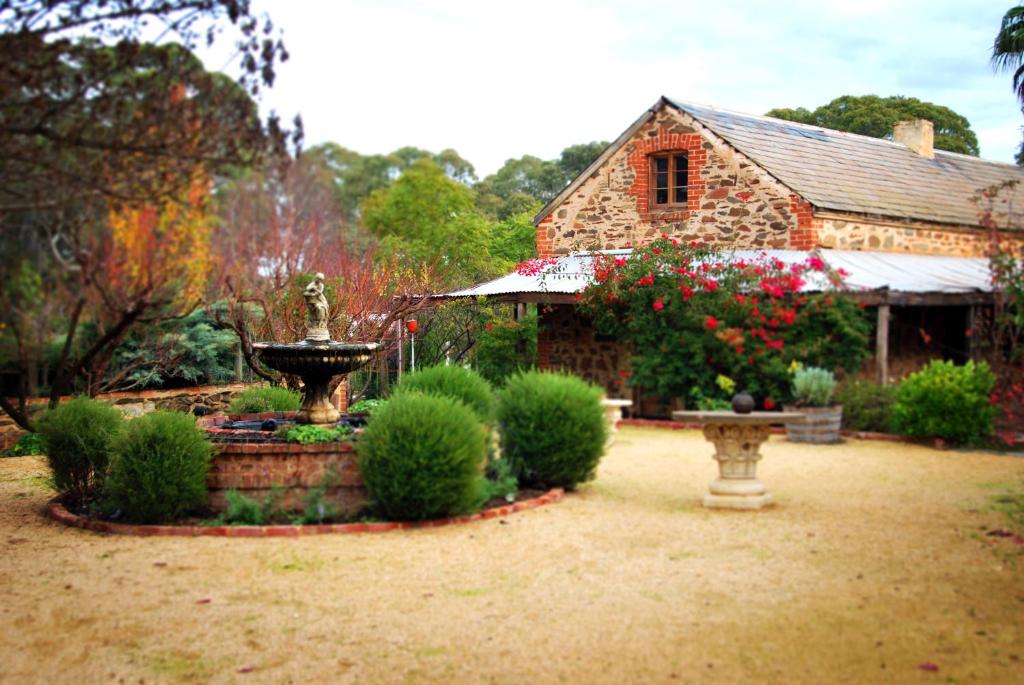 a garden area with a bench and a house at Jacobs Creek Retreat - Barossa Valley in Tanunda