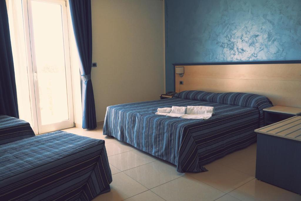 Postel nebo postele na pokoji v ubytování Grand Hotel Dei Cavalieri
