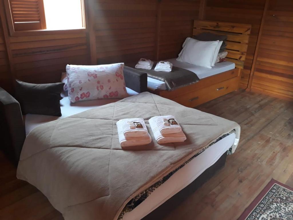 a bedroom with a large bed with towels on it at Pousada e Restaurante Redivo in Louro Müller
