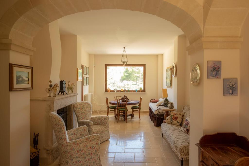 a living room with a couch and a table at Ulivo Centenario in Selva di Fasano