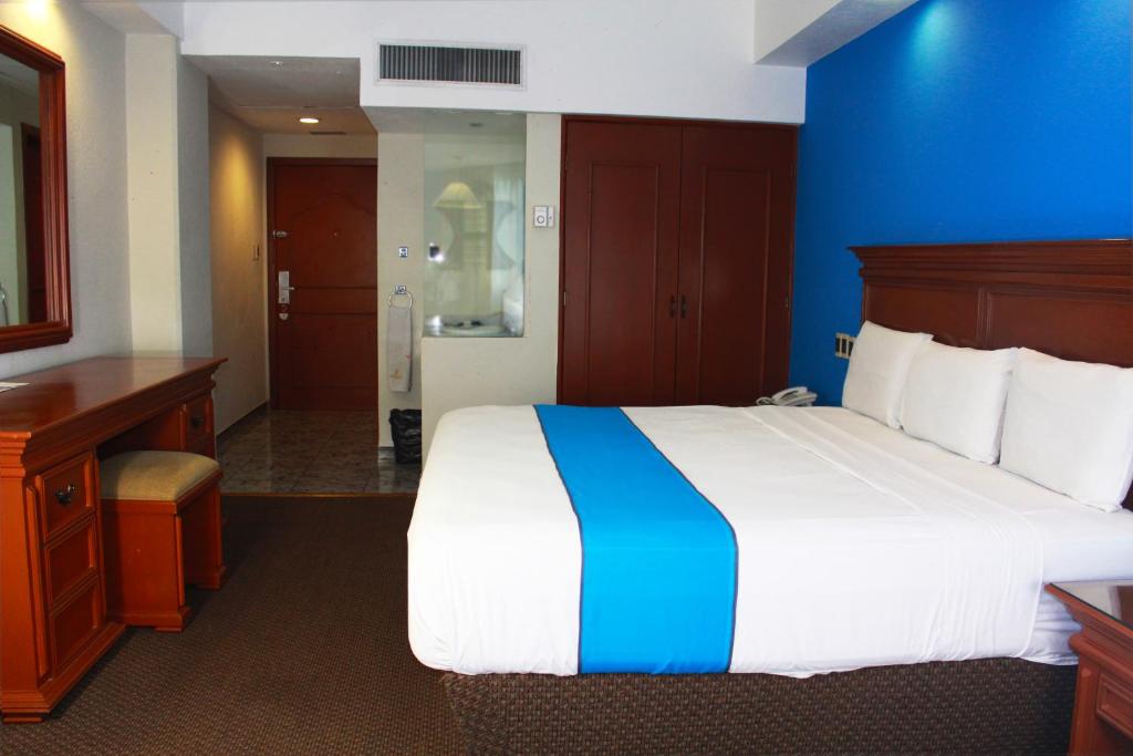 Postel nebo postele na pokoji v ubytování Hotel Lois Veracruz