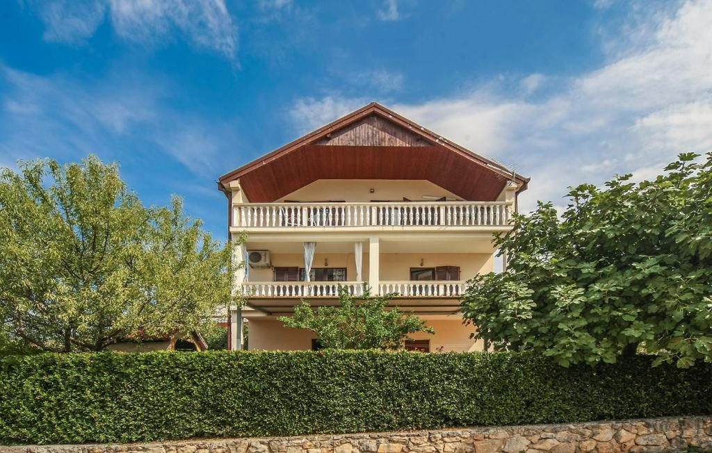 a large house with a balcony and trees at Apartments Mond in Gornji Karin