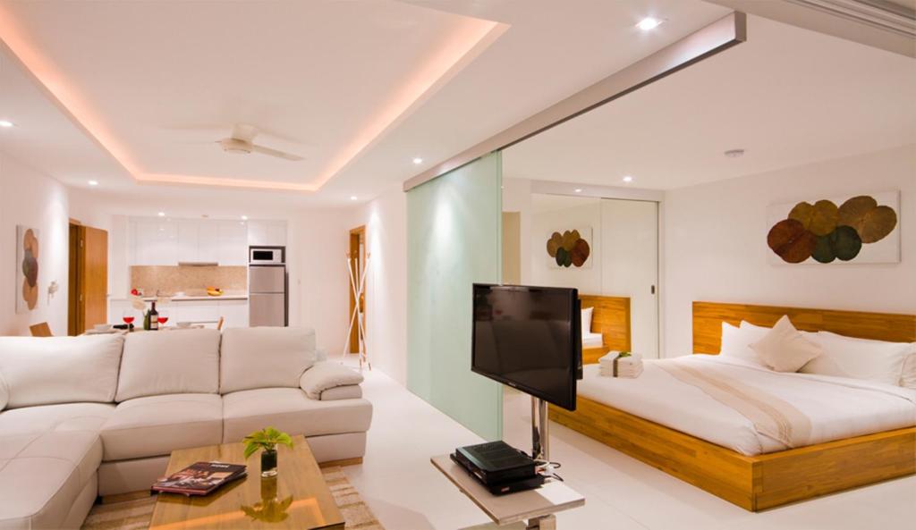 a living room with a bed and a couch at Code Samui Hotel in Mae Nam