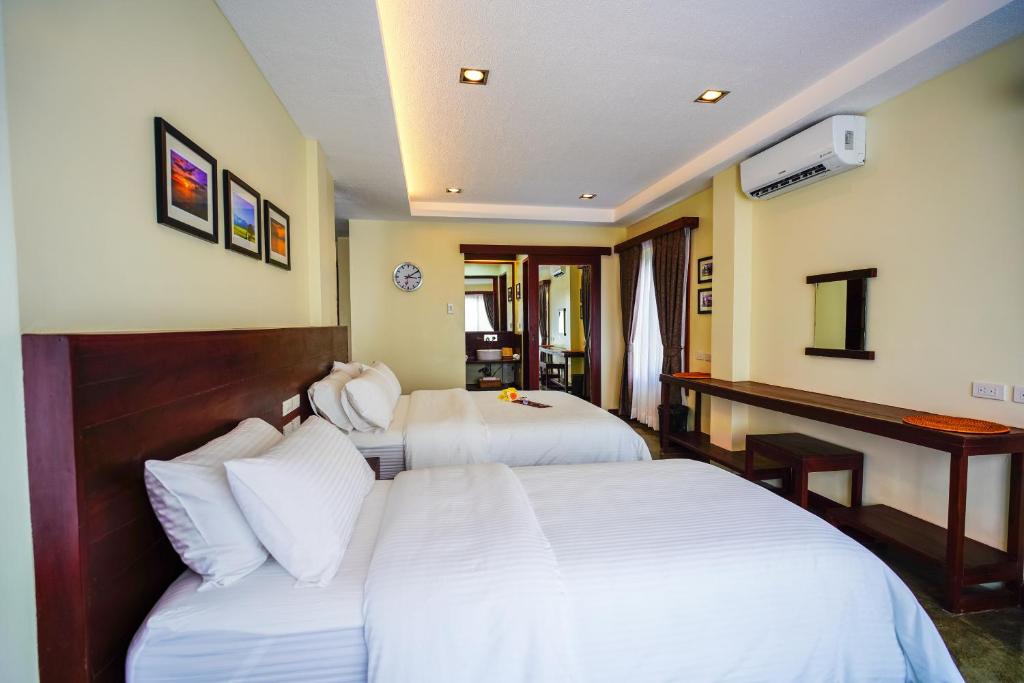 Tempat tidur dalam kamar di Retreat Siargao Resort