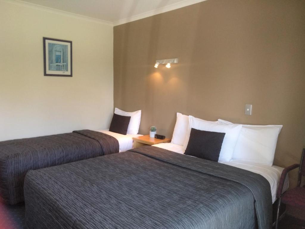 Postel nebo postele na pokoji v ubytování Stadium Motel