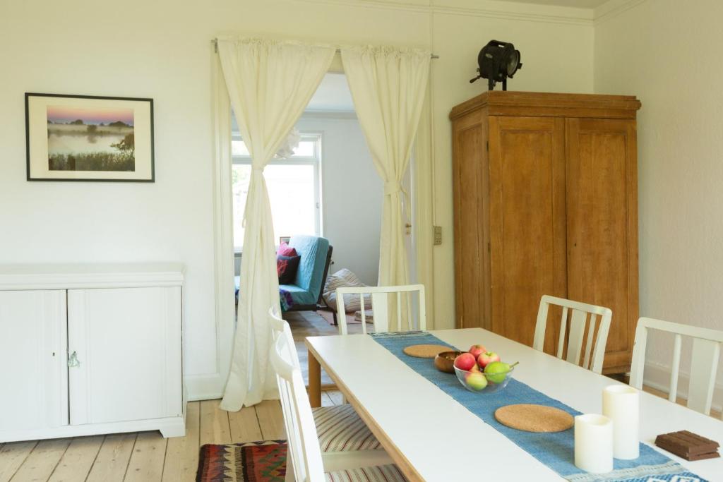 a dining room with a white table and chairs at Spacious Private Apartment for Family Holiday in Stege