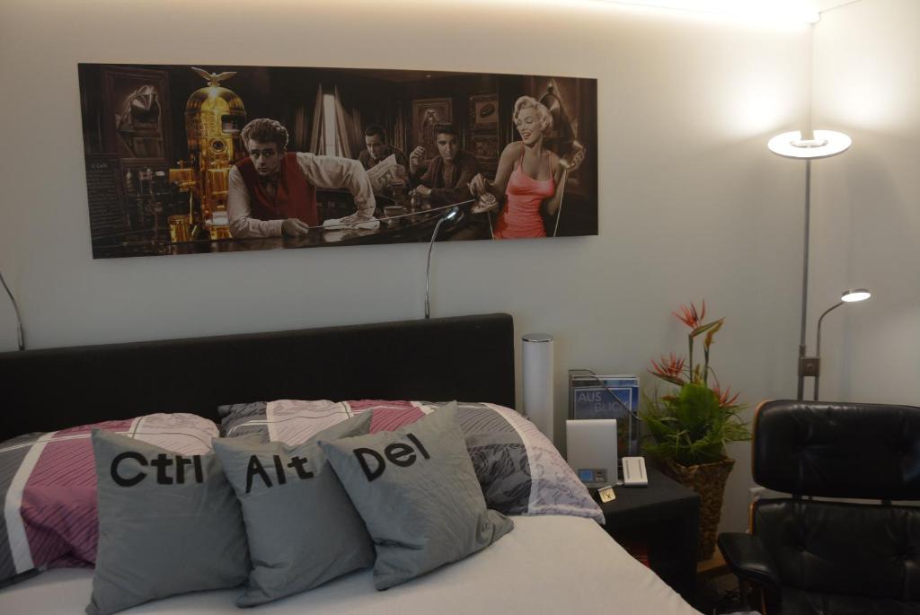 a bedroom with a bed with a poster on the wall at BnB Sirnach in Sirnach