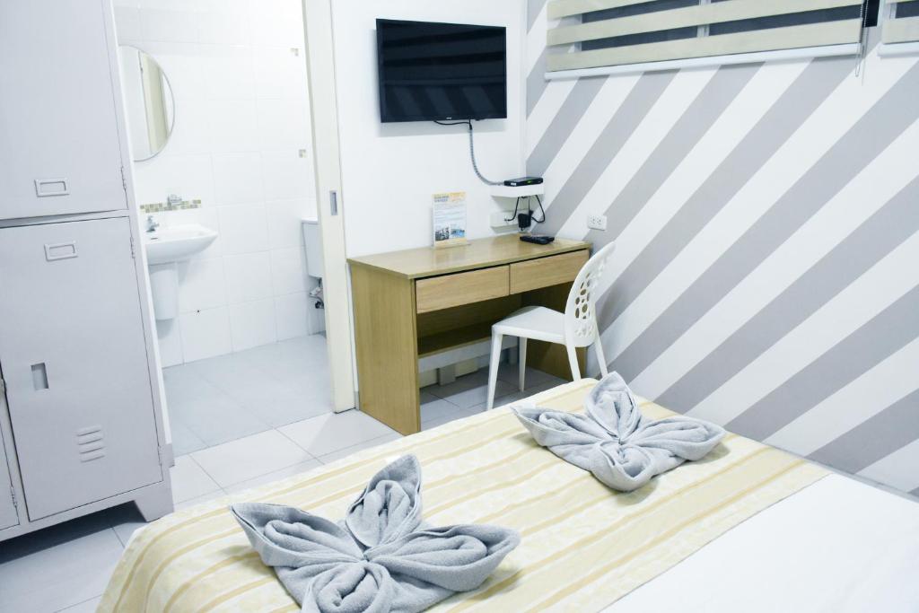 Postel nebo postele na pokoji v ubytování Alicia Tower Residences