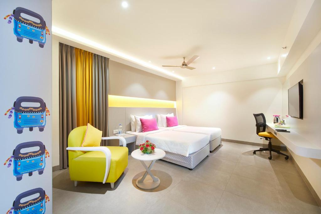 塞勒姆的住宿－ZIBE Salem By GRT Hotels，酒店客房,配有床和黄色椅子