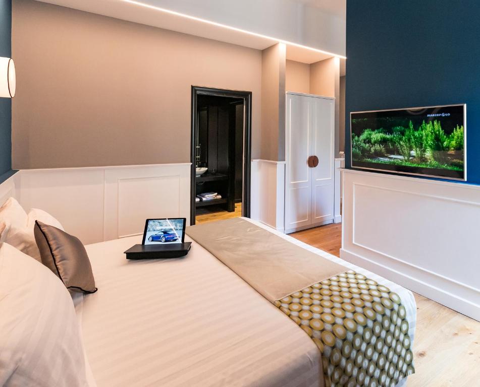 a bedroom with a bed and a flat screen tv at Jb Relais Luxury in Rome