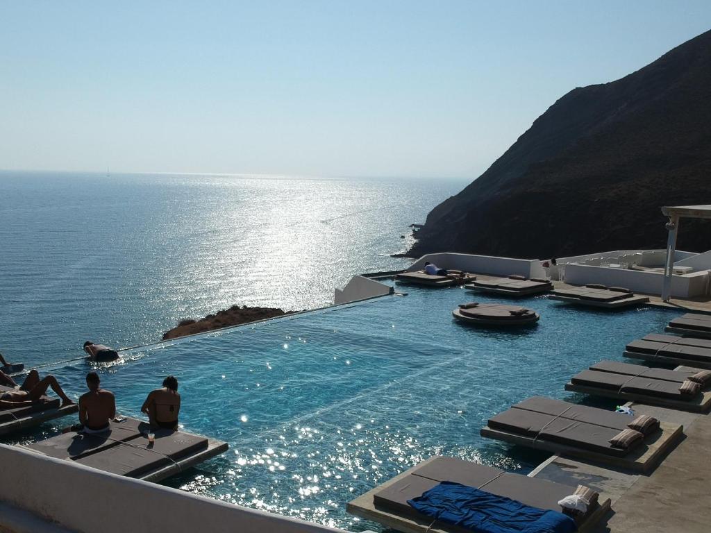 a swimming pool with a view of the ocean at Golden Beach Resort Anafi in Anafi