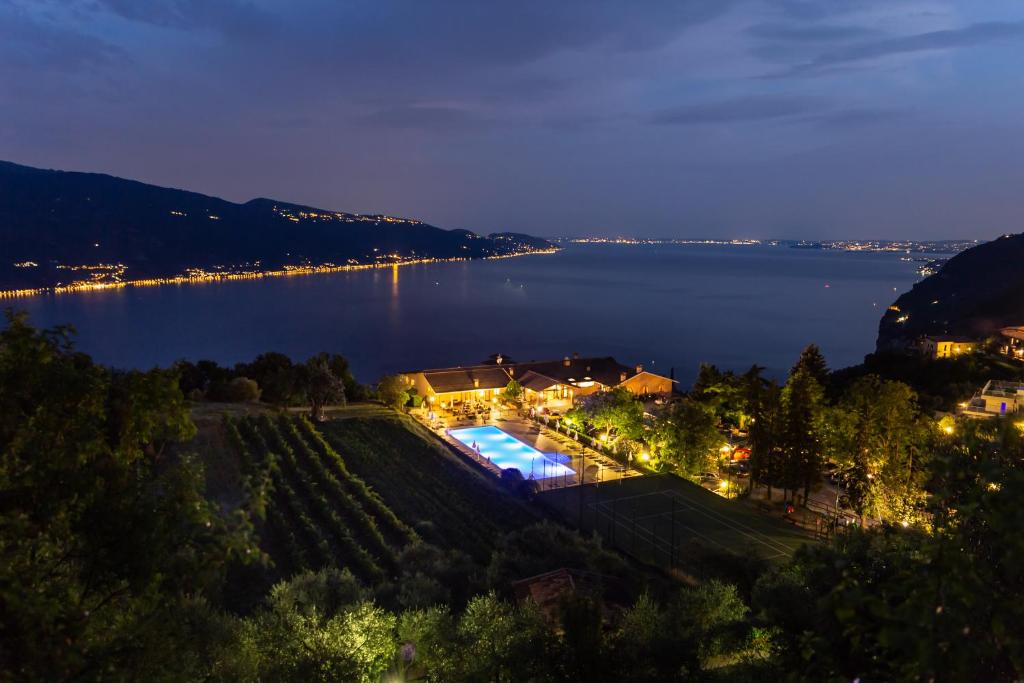 a view of a large lake at night at Park Hotel Zanzanù in Tignale