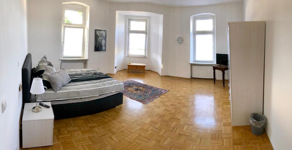 a bedroom with a bed and a wooden floor at Ferienwohnung Branka in Essen